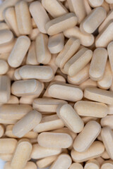 Top view of a variety of yellow pharmaceutical pills, vitamins, antibiotics, capsules concept of pharmacy, health, medicine, business, pharmaceutical, background. selective focus.