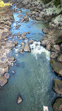 The South Esk River, shallow in its course, cascades over a bed of moss-covered igneous dolerite rock, creating a sequence of cataracts.
