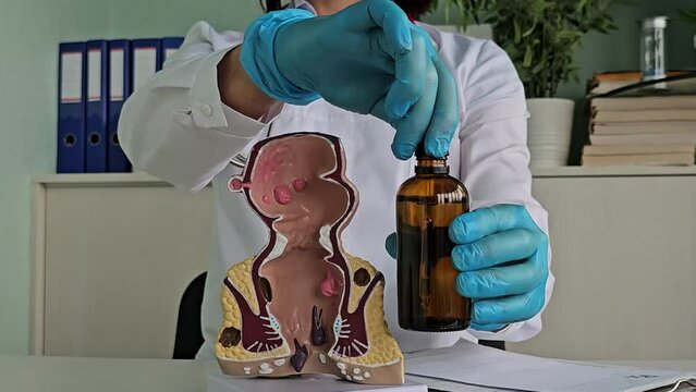 Proctologist holds Vaseline oil for constipation in the rectum