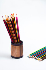 Wooden colored pencils on white background