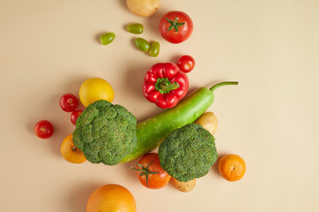 Fresh vegetables and fruits theme photo for promote product has natural composition. Variety vegetables and fruits spread evenly on table, copy space for text, top view