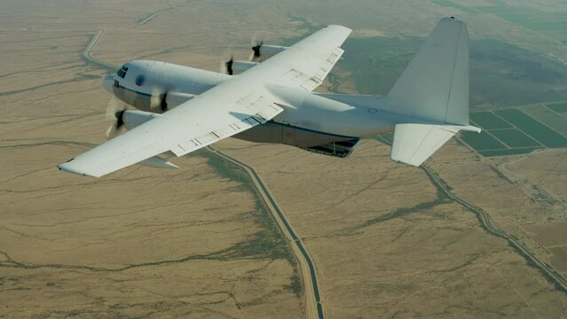 Flying alongside massive cargo airplane and parachuter sliding out back with inflatable toy 