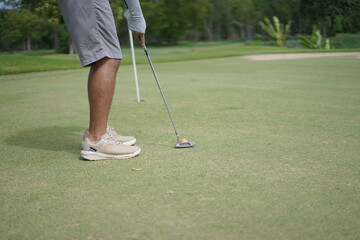 Asian man enjoy playing golf.