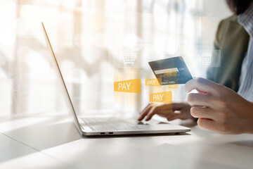 Online shopping and credit card payment concept, person is shopping on an online shopping website, purchasing goods and services securely, debiting credit card to pay for goods on the internet.