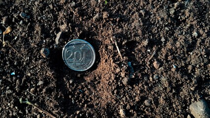 20 cent Singapore coin on the ground