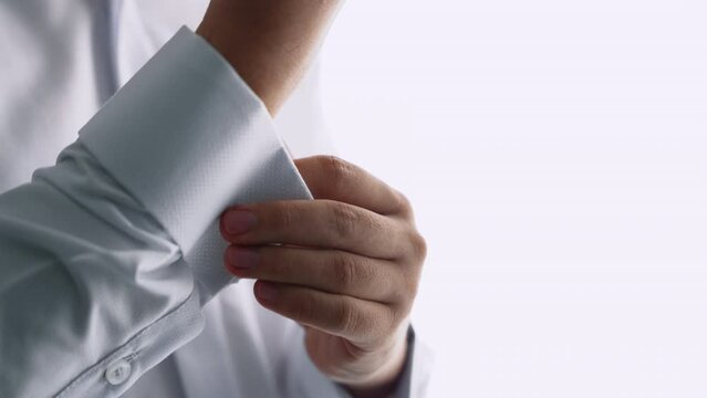 Close up of unrecognizable groom putting on cufflinks - Slow Motion 4K