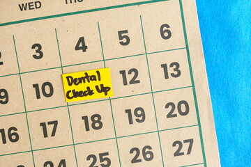 Dental check up schedule concept. Written reminder note on calendar.
