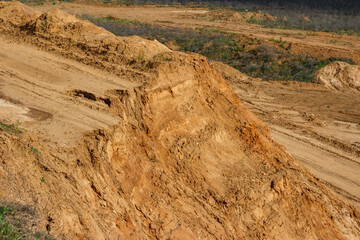 Road embankment on a sand quarry ending with a sharp cliff