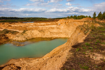 Steep slope of a sand and gravel quarry, view from the edge