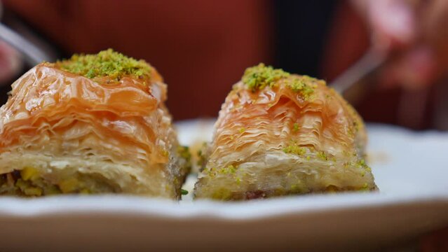 cutting handmade turkish dessert baklava with knife 