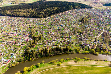 Dense dacha development near the river, view from a great height