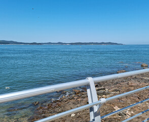 This is a seascape with a guardrail.