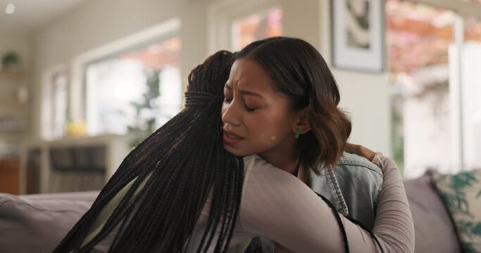 Friends, hug and crying woman on couch with conversation and trust from talking with empathy. Kindness, advice and solidarity with helping, care and comfort for mental health and stress in home