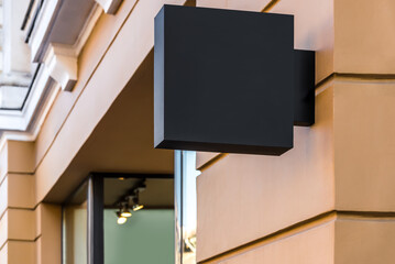 Blank Mockup Of Restaurant Street Square Black Banner Signboard On Yellow Wall