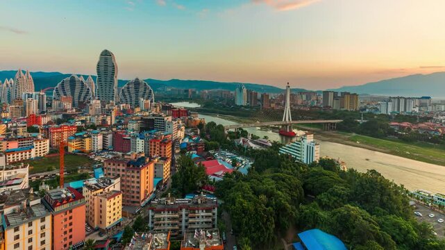 Spectacular Real shot Buddhist Temple, City skyline Buildings in Chinese Touristic Travel Destination of Xishuangbanna, sunset timelapse
