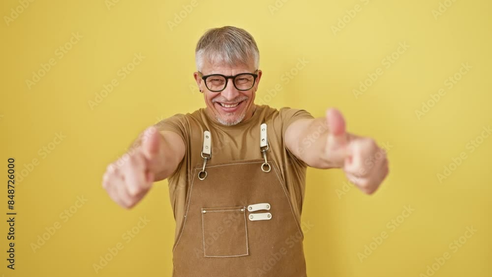 Sticker cheerful middle age, grey-haired man wearing glasses, apron, and flashing thumbs up, standing happy 