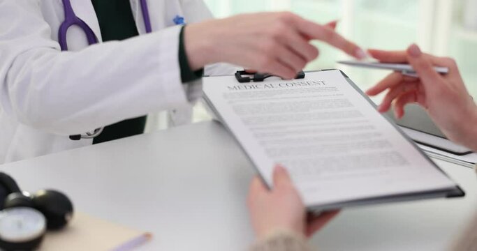 Healthcare provider gives medical consent form to patient