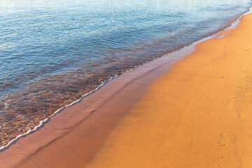 Soft wave of the sea on the sandy beach.