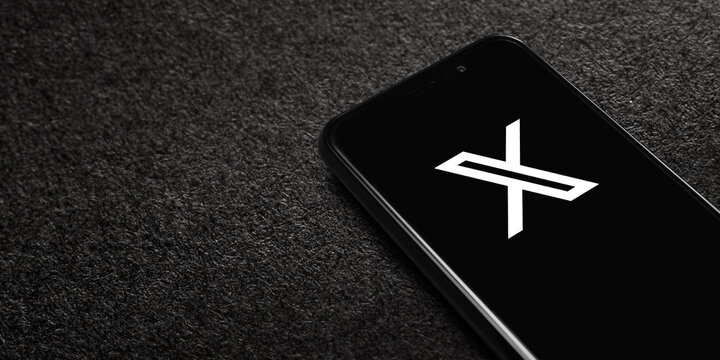 X logo on smartphone screen on black textured background. X, commonly referred to by its former name Twitter, is a social networking service. Astana, Kazakhstan - June 13, 2024.