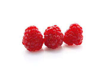 ripe red raspberries isolated on a white background