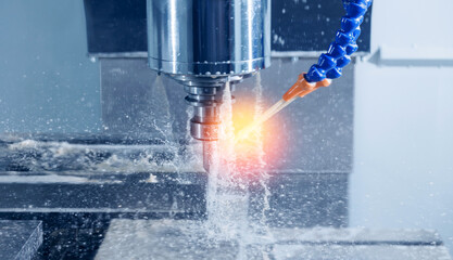 Closeup CNC milling machine during operation with engine turbine housing. Produced cutting metal...