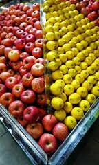 Midsection of lemon and apple fruit on stall
