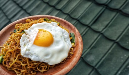 a close up of a plate of noodles with an egg on top