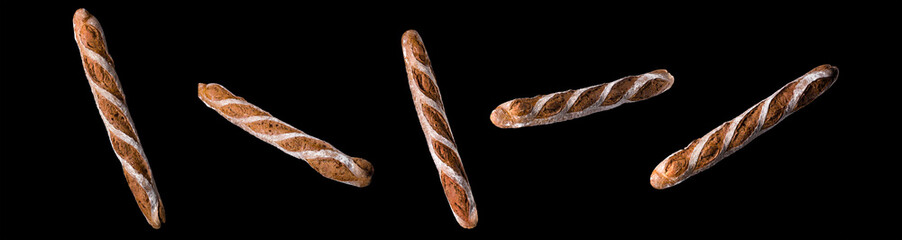 Set of fresh baked bread and French rye baguette isolated on black background