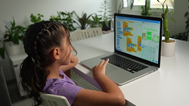 Hispanic Girl Student Coding a Video Game with a Laptop. STEAM, Mathematics Engineering Science Technology Computer Code Concept.