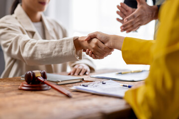 Business lawyers workers meeting at law firm office. Professional executive partners working on finance strategry at the workplace. Shaking hands for succesful agreement.