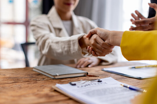 Business lawyers workers meeting at law firm office. Professional executive partners working on finance strategry at the workplace. Shaking hands for succesful agreement.