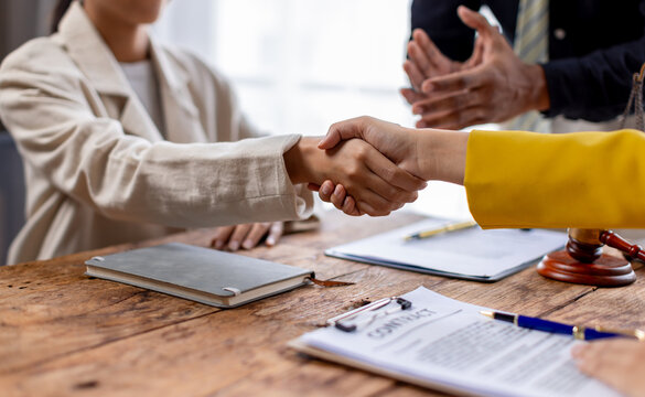 Business lawyers workers meeting at law firm office. Professional executive partners working on finance strategry at the workplace. Shaking hands for succesful agreement.