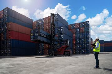 Foreman control loading Containers box from Cargo freight ship for import export. Logistic Concept