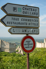 A Road Sign above the Backdrop of Castle Gaillard, near Andelys France in Normandy.