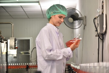 QC manager inspecting the quality of a beverage product in the production process