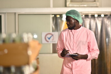African worker are working in beverage factory.