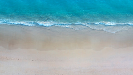  Tropical Beach with the soft wave water of the sea on the sandy beach background as texture with splashes and bubbles