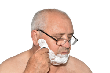 Portrait of a man applying razor foam to his cheek to shave his cheek with a machine.