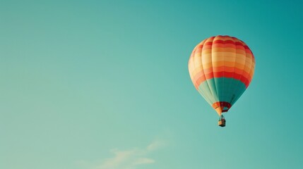Obraz premium colorful hot air balloon drifting across a clear blue summer sky, blank space, airborne adventure, high contrast