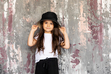High fashion look.glamor stylish beautiful happy surprised little girl model in summer black and white cloth on background. Emotion.
