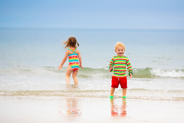 Kids playing on beach. Children play at sea.