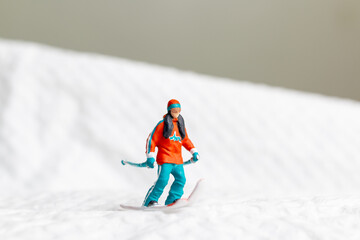 A miniature figurine of a skier dressed in vibrant winter gear. This image is perfect for themes...