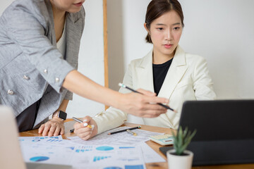 Two businesswoman meeting and data analysis and statistics report for budget an office