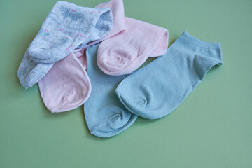 Children's socks on a green background.