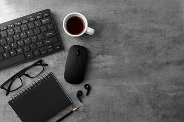 Keyboard and notebook and coffee on stone texture background. Work desk space
