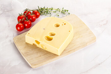 Maasdam cheese brick over board