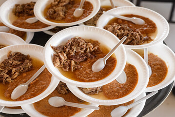 Piled plastic plates with typical mexican food. Food service for an event.
