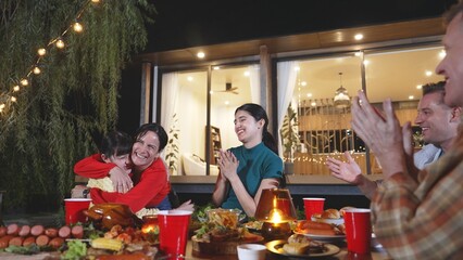Family gather celebrate holiday. Kind grandmother hug little daughter for showing love and warmly...