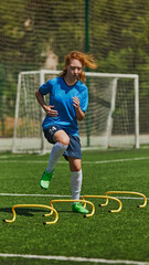 Youth Soccer Skill Development. Girl in sporty outfit practicing speed and agility using agility ladder. Outdoor soccer training session. Concept of sport, school, childhood, hobby, active lifestyle