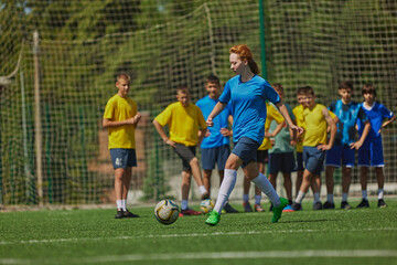 Athletic Training for Kids. Diverse group of children wear soccer uniforms and training on outdoor field. Concept of sport, school, childhood, hobby, active lifestyle